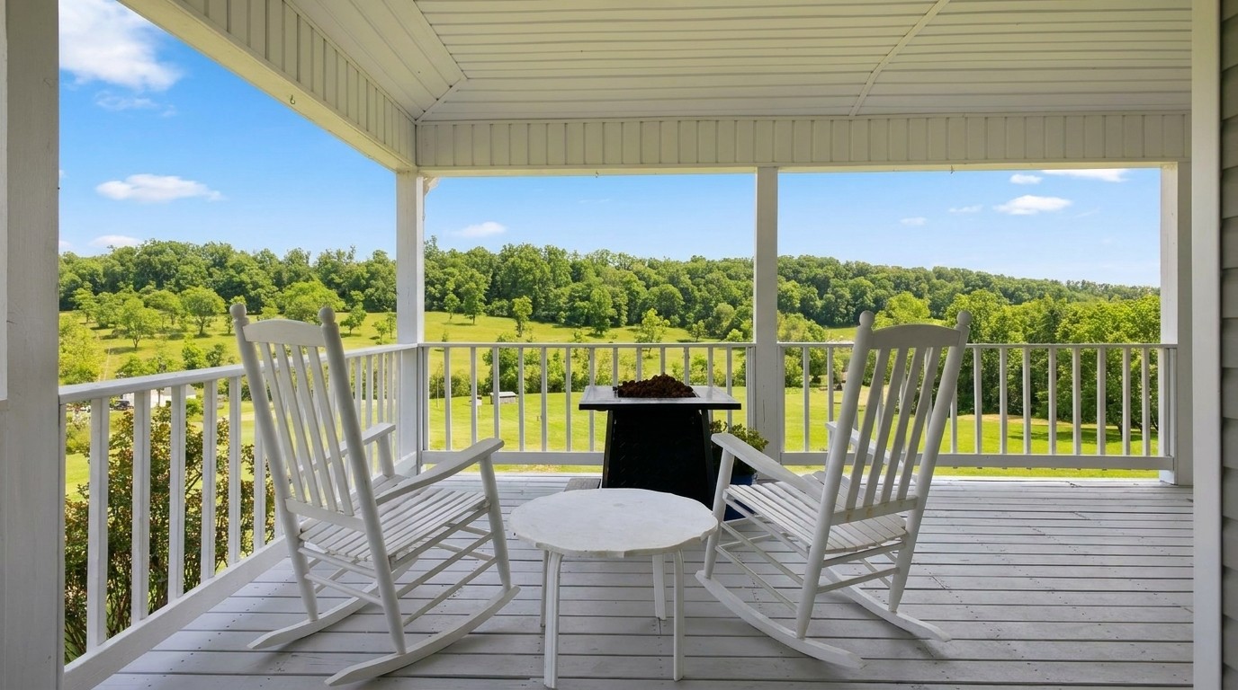 Rocking chairs framing valley views from the covered deck