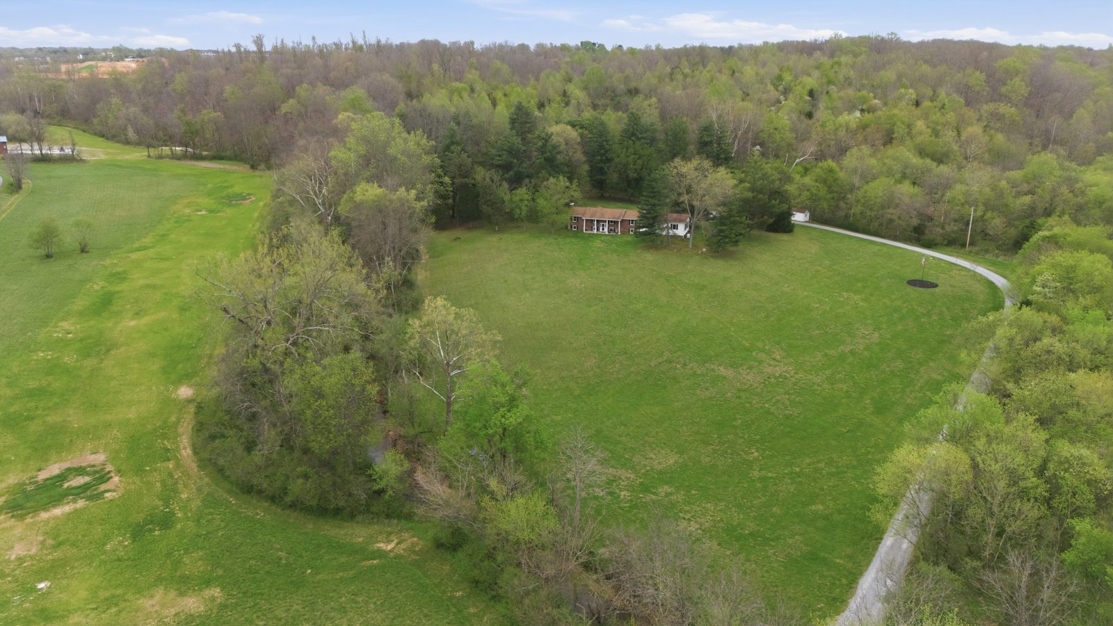 Aerial view of the home set on 18.5 acres of pasture and woods near Dickson, Tennessee