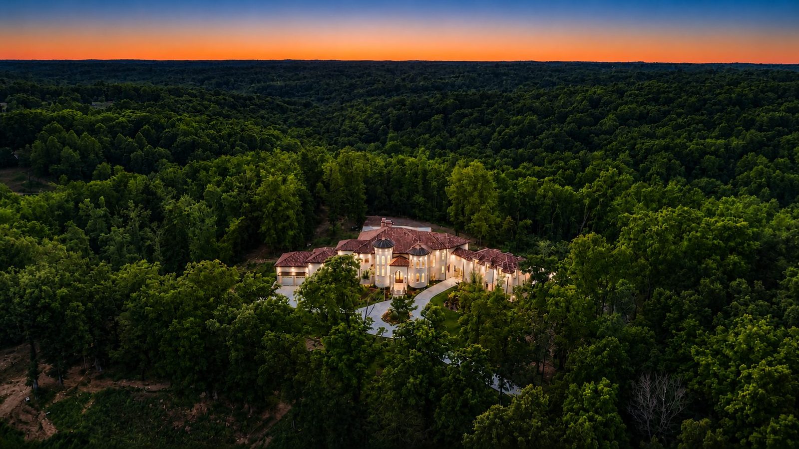 Aerial view of the Primm Springs estate set deep within wooded hills at sunset