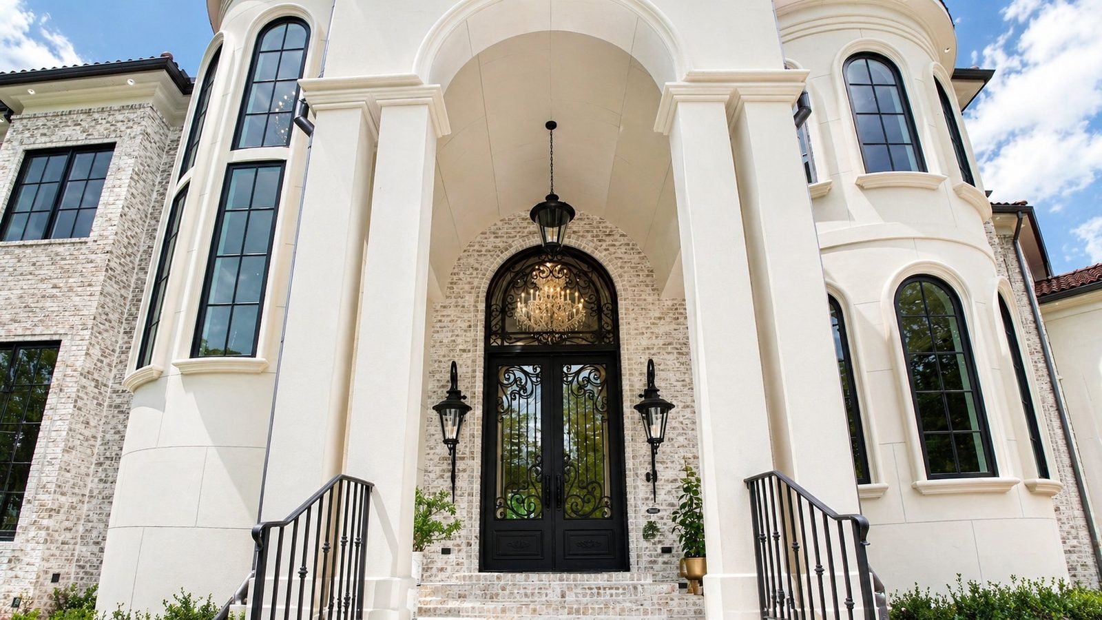 The grand iron and glass entry beneath the arched portico